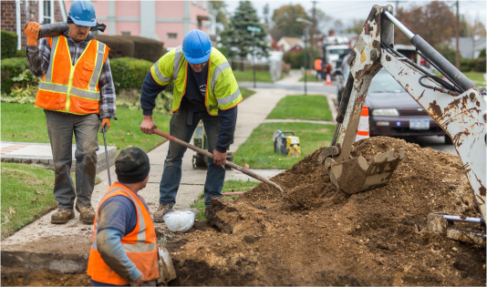 Workers digging hole